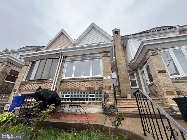 6207 Gardenia St, Philadelphia, PA 19144 - rear view of house featuring brick siding and a patio