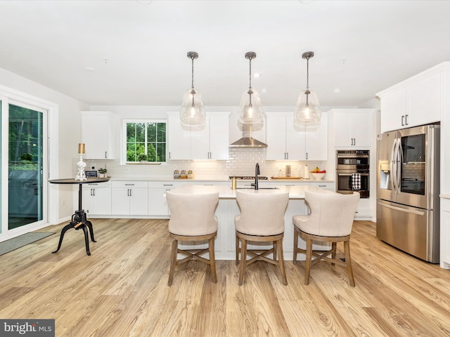 704 Kaplon Ct, Brunswick, MD 21716 - kitchen with appliances with stainless steel finishes, light wood-type flooring, tasteful backsplash, and white cabinetry