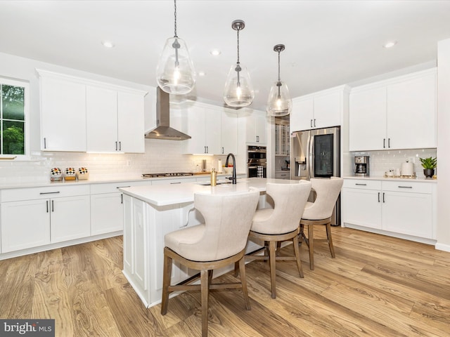 704 Kaplon Ct, Brunswick, MD 21716 - kitchen with wall chimney range hood, tasteful backsplash, a sink, stainless steel appliances, and a kitchen breakfast bar