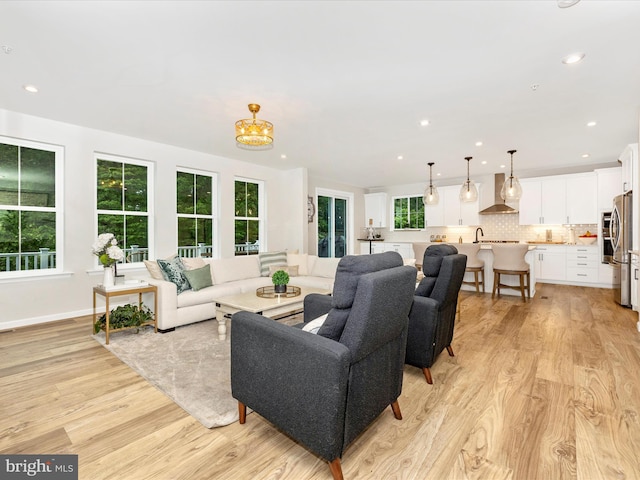 704 Kaplon Ct, Brunswick, MD 21716 - living area with light wood-style floors, a chandelier, recessed lighting, and baseboards