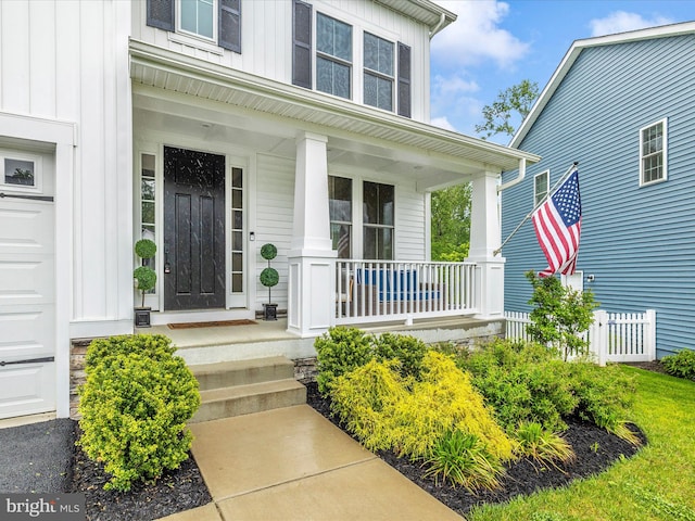 704 Kaplon Ct, Brunswick, MD 21716 - entrance to property featuring board and batten siding, a porch, and a garage