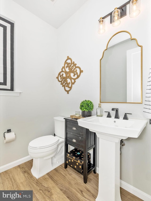 704 Kaplon Ct, Brunswick, MD 21716 - bathroom with wood finished floors, toilet, and baseboards