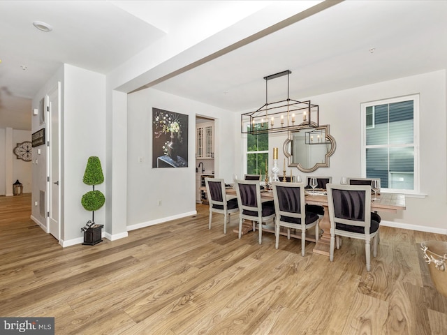 704 Kaplon Ct, Brunswick, MD 21716 - dining space featuring wood finished floors, baseboards, and a chandelier