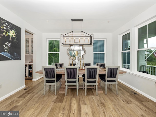 704 Kaplon Ct, Brunswick, MD 21716 - dining room with a chandelier, wood finished floors, and baseboards