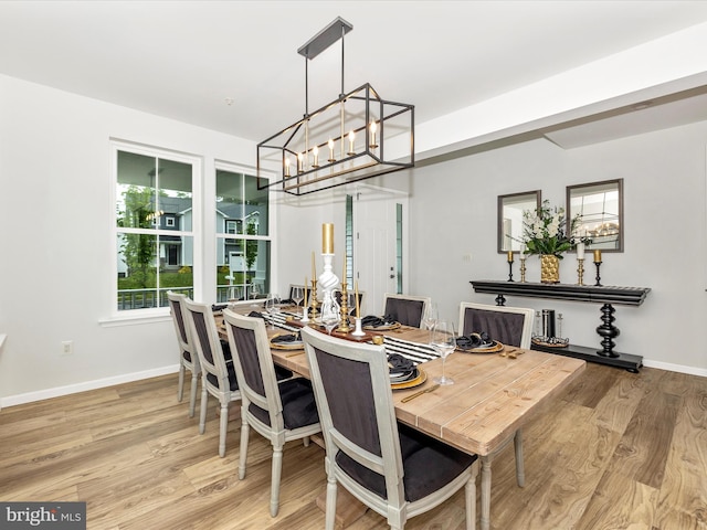 704 Kaplon Ct, Brunswick, MD 21716 - dining area featuring a chandelier, wood finished floors, and baseboards