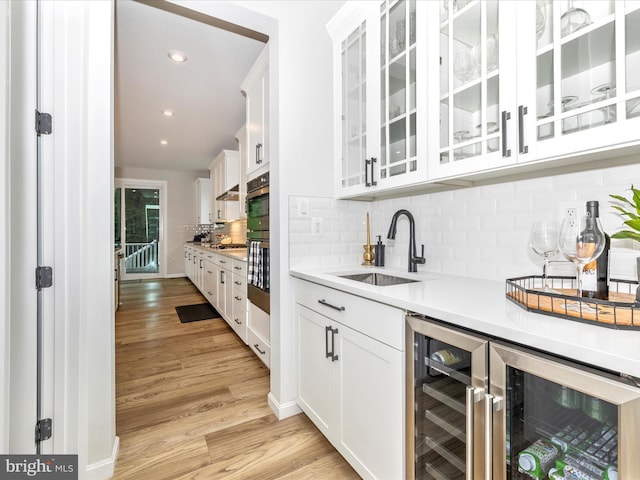 704 Kaplon Ct, Brunswick, MD 21716 - indoor bar with beverage cooler, light wood finished floors, tasteful backsplash, recessed lighting, and appliances with stainless steel finishes