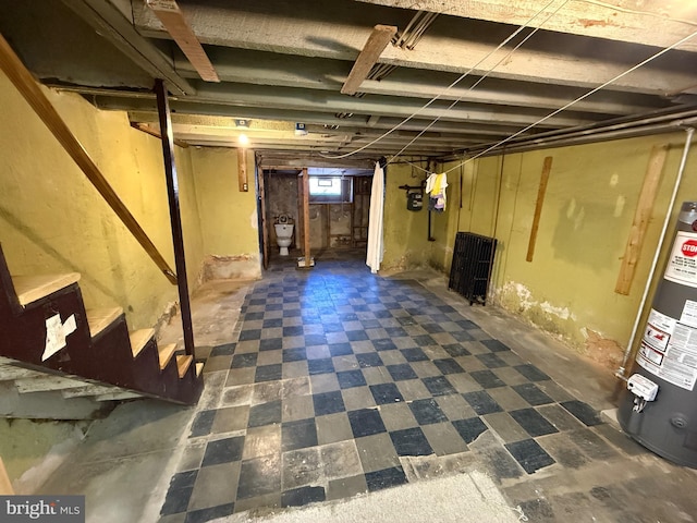 below grade area with tile patterned floors and water heater