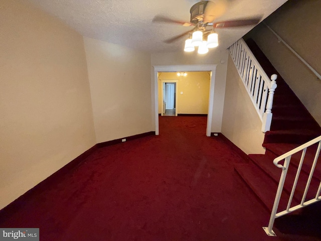 interior space with stairway, carpet flooring, baseboards, and a ceiling fan