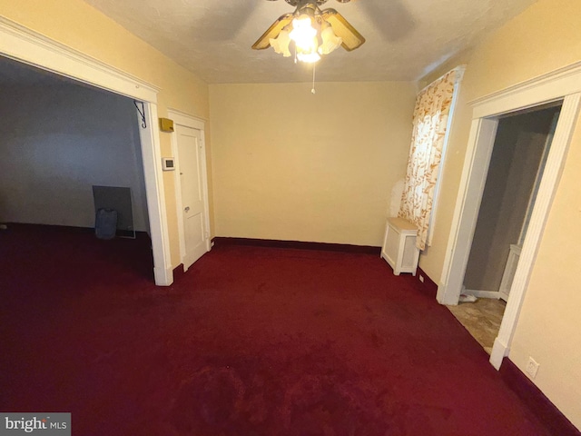 interior space featuring carpet, baseboards, a ceiling fan, and radiator