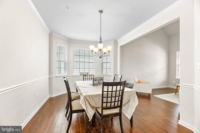 dining area with baseboards, a chandelier, ornamental molding, and dark wood-style flooring