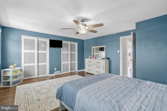 bedroom featuring visible vents, ceiling fan, wood finished floors, and baseboards