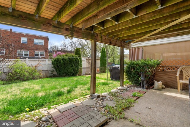 view of yard featuring fence and a patio