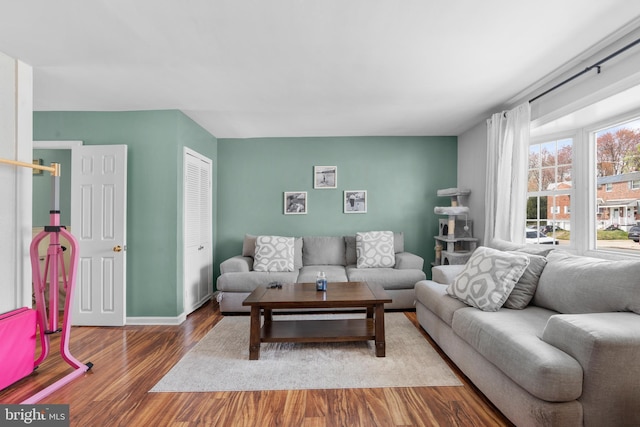 living area with wood finished floors and baseboards