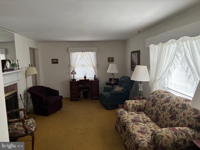 living room with light carpet and a brick fireplace