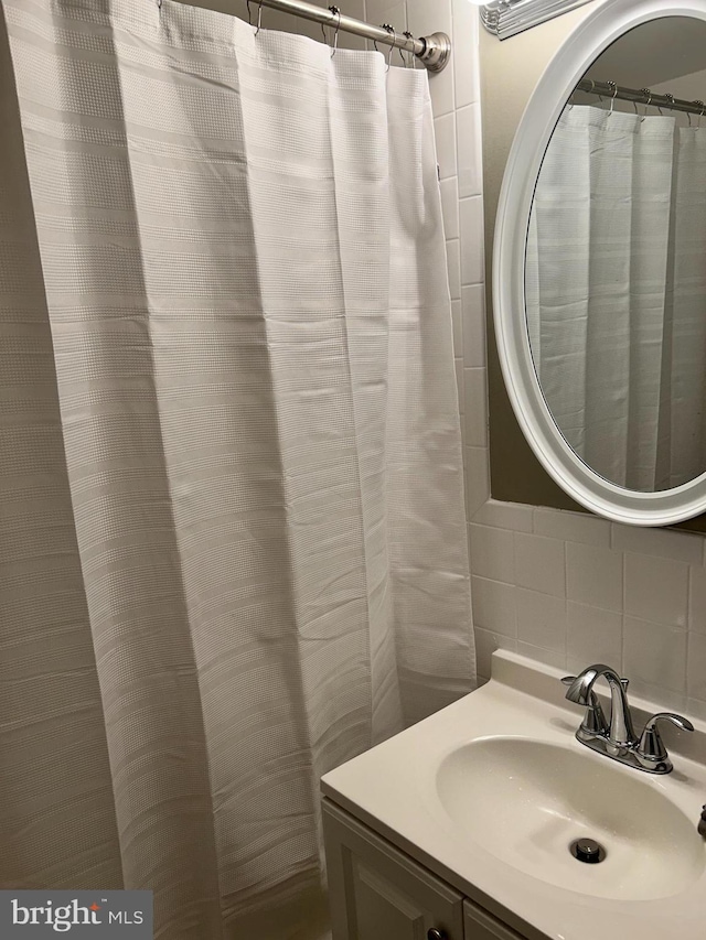 110 Woodland Ave, Norwood, PA 19074 - full bathroom featuring backsplash, tile walls, and vanity