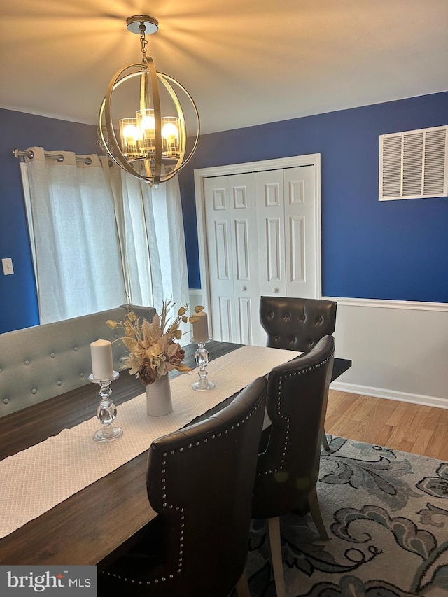 110 Woodland Ave, Norwood, PA 19074 - dining room with baseboards, visible vents, wood finished floors, and a notable chandelier