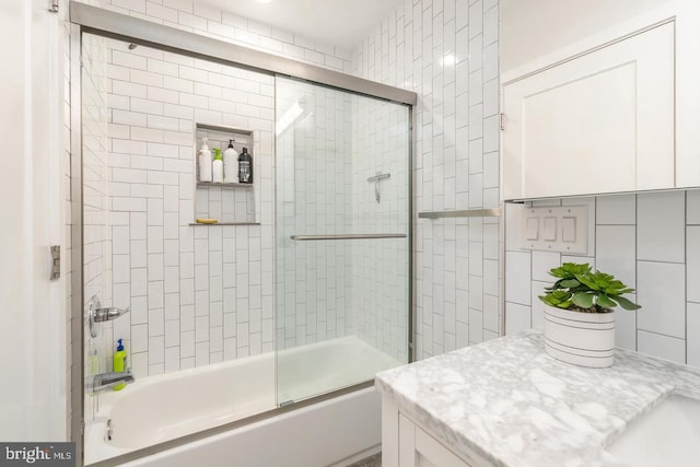 2625 Pratt St, Philadelphia, PA 19137 - bathroom with bath / shower combo with glass door, vanity, and tile walls