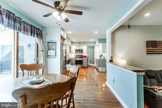 dining room featuring recessed lighting, light wood-style flooring, and a ceiling fan