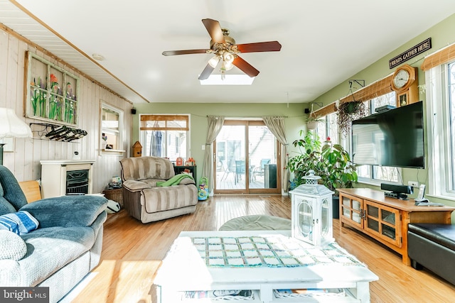 living room featuring a ceiling fan and wood finished floors