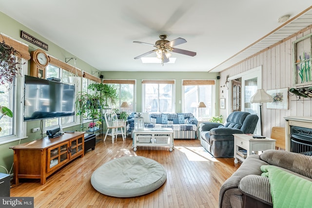 living area with hardwood / wood-style floors and a ceiling fan