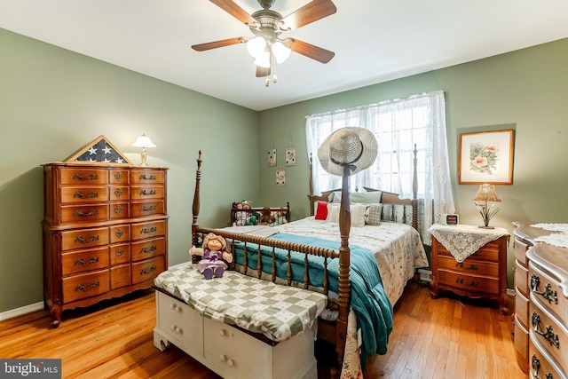 bedroom with a ceiling fan and light wood-style flooring