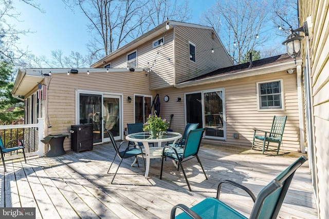 wooden deck with outdoor dining space