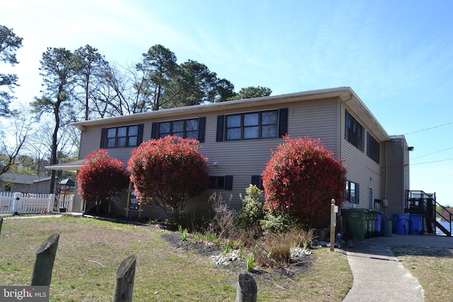 view of front of property with fence and a front yard