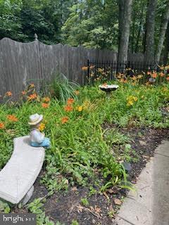 view of yard with a vegetable garden and fence