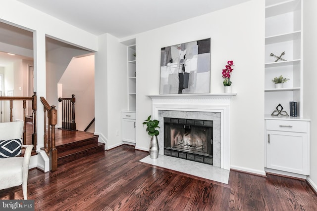 9644 Sutton Green Ct, Vienna, VA 22181 - living area with built in shelves, wood finished floors, a high end fireplace, and stairway