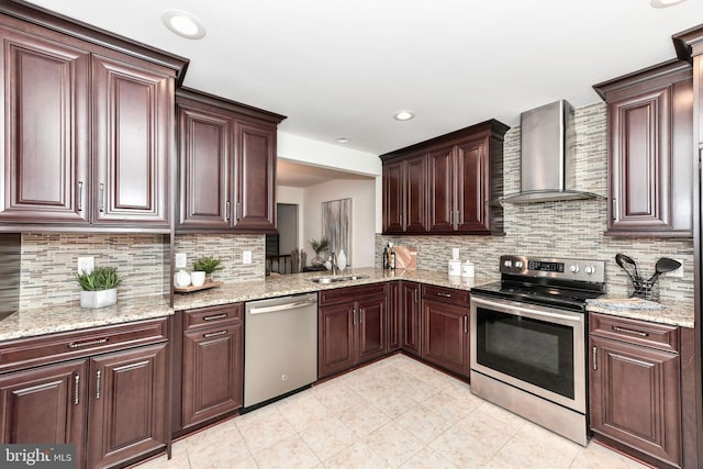 9644 Sutton Green Ct, Vienna, VA 22181 - kitchen featuring appliances with stainless steel finishes, wall chimney exhaust hood, a sink, backsplash, and light stone counters