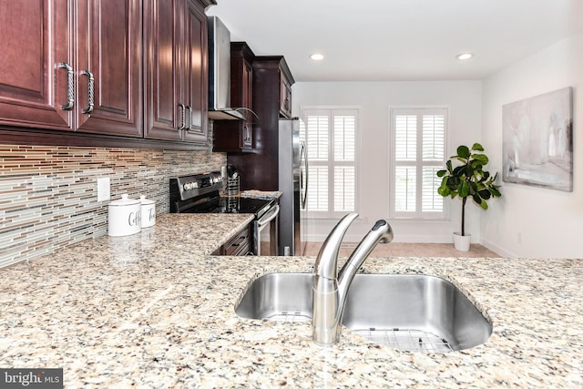 9644 Sutton Green Ct, Vienna, VA 22181 - kitchen with appliances with stainless steel finishes, wall chimney range hood, a sink, light stone counters, and recessed lighting