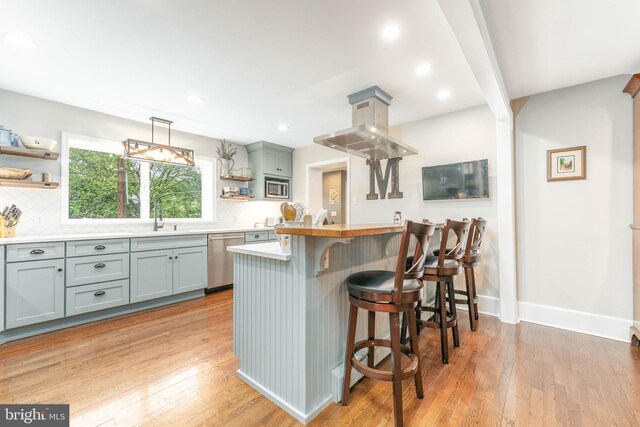 90 Indiantown Rd, Glenmoore, PA 19343 - kitchen with open shelves, appliances with stainless steel finishes, a breakfast bar area, decorative backsplash, and recessed lighting