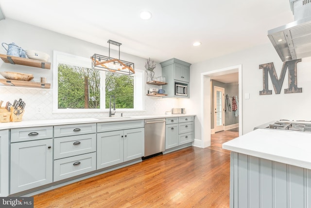 90 Indiantown Rd, Glenmoore, PA 19343 - kitchen with stainless steel appliances, open shelves, a sink, backsplash, and range hood