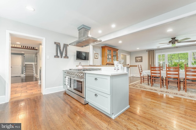 90 Indiantown Rd, Glenmoore, PA 19343 - kitchen featuring range with two ovens, island exhaust hood, baseboards, light wood-type flooring, and recessed lighting