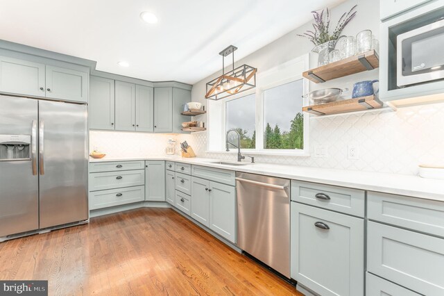 90 Indiantown Rd, Glenmoore, PA 19343 - kitchen featuring stainless steel appliances, open shelves, a sink, light countertops, and decorative backsplash