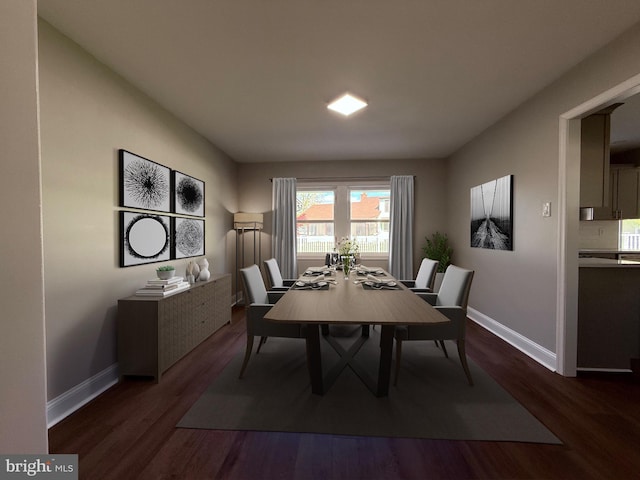 dining area featuring baseboards and dark wood finished floors