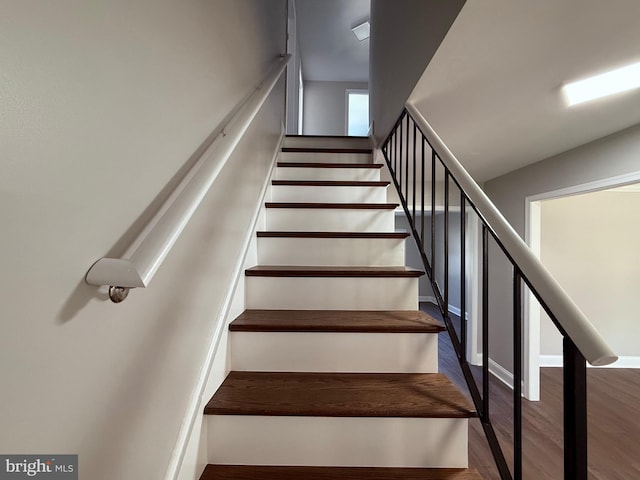 staircase featuring wood finished floors