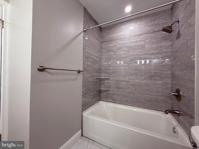 full bathroom with baseboards, marble finish floor, and shower / washtub combination