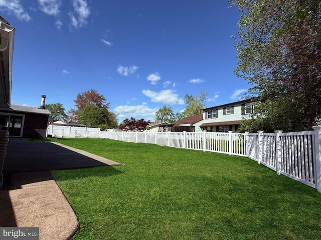 view of yard featuring a patio and a fenced backyard