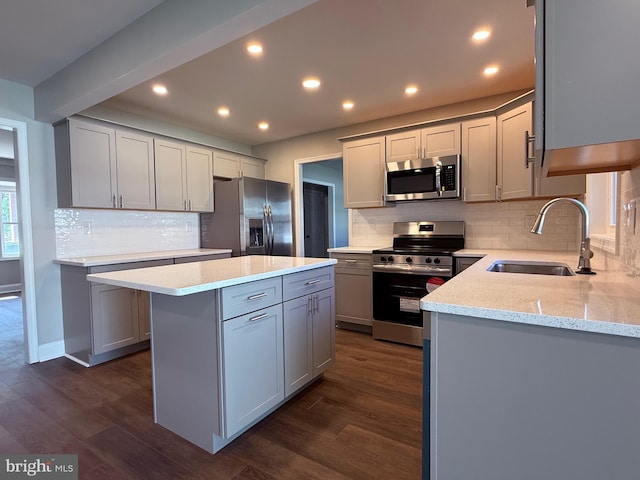 kitchen with dark wood-style flooring, gray cabinets, appliances with stainless steel finishes, and a sink