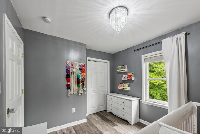 5939 Meadow Rd, Frederick, MD 21701 - bedroom with light wood-type flooring, baseboards, a chandelier, and a closet