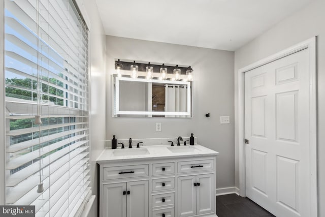 5939 Meadow Rd, Frederick, MD 21701 - full bathroom featuring double vanity, baseboards, and wood finished floors