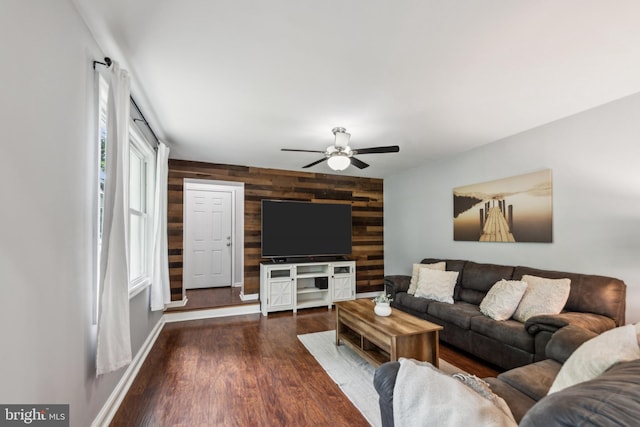 5939 Meadow Rd, Frederick, MD 21701 - living area featuring wooden walls, an accent wall, a ceiling fan, wood finished floors, and baseboards