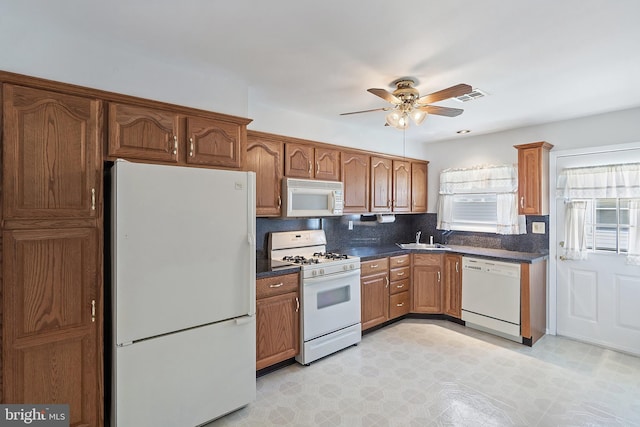 17 Hyannis St, Toms River, NJ 08757 - kitchen with dark countertops, a sink, brown cabinetry, white appliances, and ceiling fan