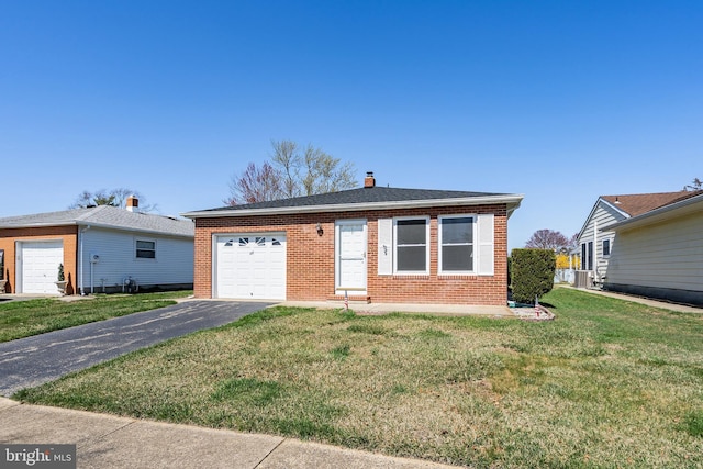 17 Hyannis St, Toms River, NJ 08757 - view of front of property with brick siding, a front lawn, a garage, and aphalt driveway