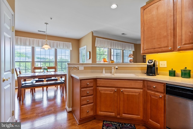207 Secretariat Dr Unit M, Havre De Grace, MD 21078 - kitchen featuring a sink, dishwasher, a peninsula, light countertops, and wood finished floors