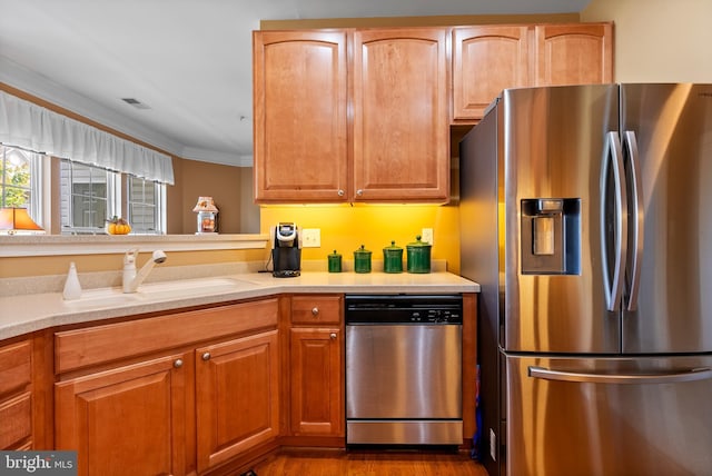 207 Secretariat Dr Unit M, Havre De Grace, MD 21078 - kitchen featuring stainless steel appliances, light countertops, a sink, crown molding, and dark wood-style flooring