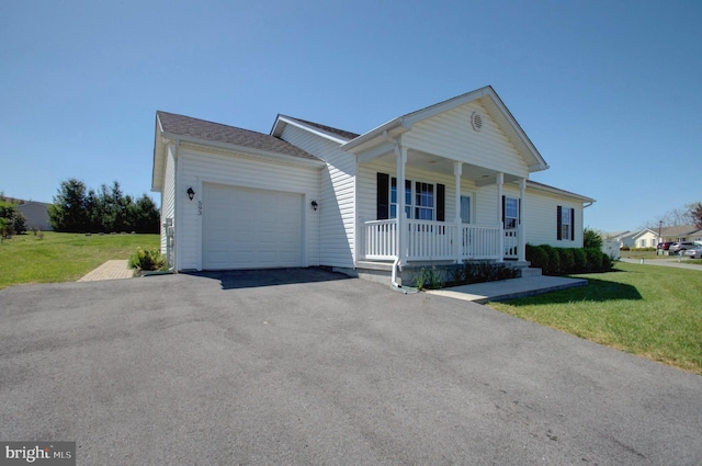 ranch-style house featuring covered porch, a front yard, driveway, and an attached garage
