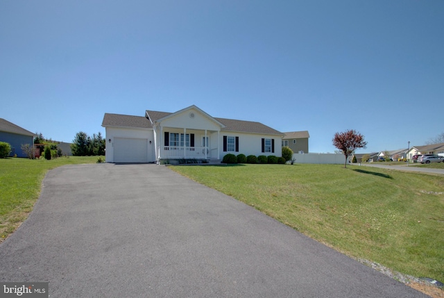 single story home with aphalt driveway, a front yard, a porch, and an attached garage