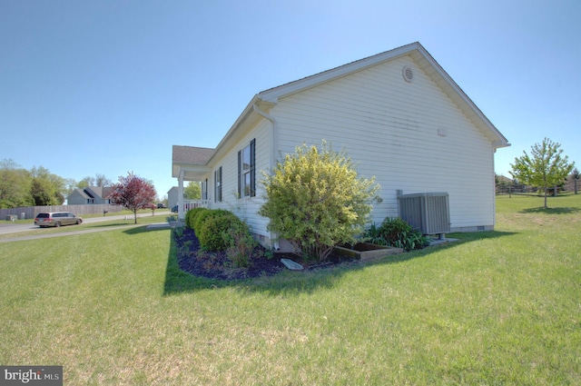 view of home's exterior featuring crawl space, central AC unit, and a lawn